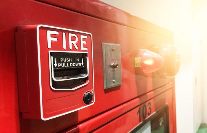 a red fire alarm switch. red fire alarm. Push in pull down.