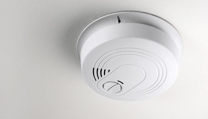 A smoke detector installed on a ceiling
